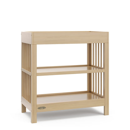 Graco Teddi Changing Table with Water-Resistant Changing Pad (Driftwood) - GREENGUARD Gold Certified, 2 Open Shelves, Includes Bonus Water-Resistant Changing Pad with Safety Strap Graco